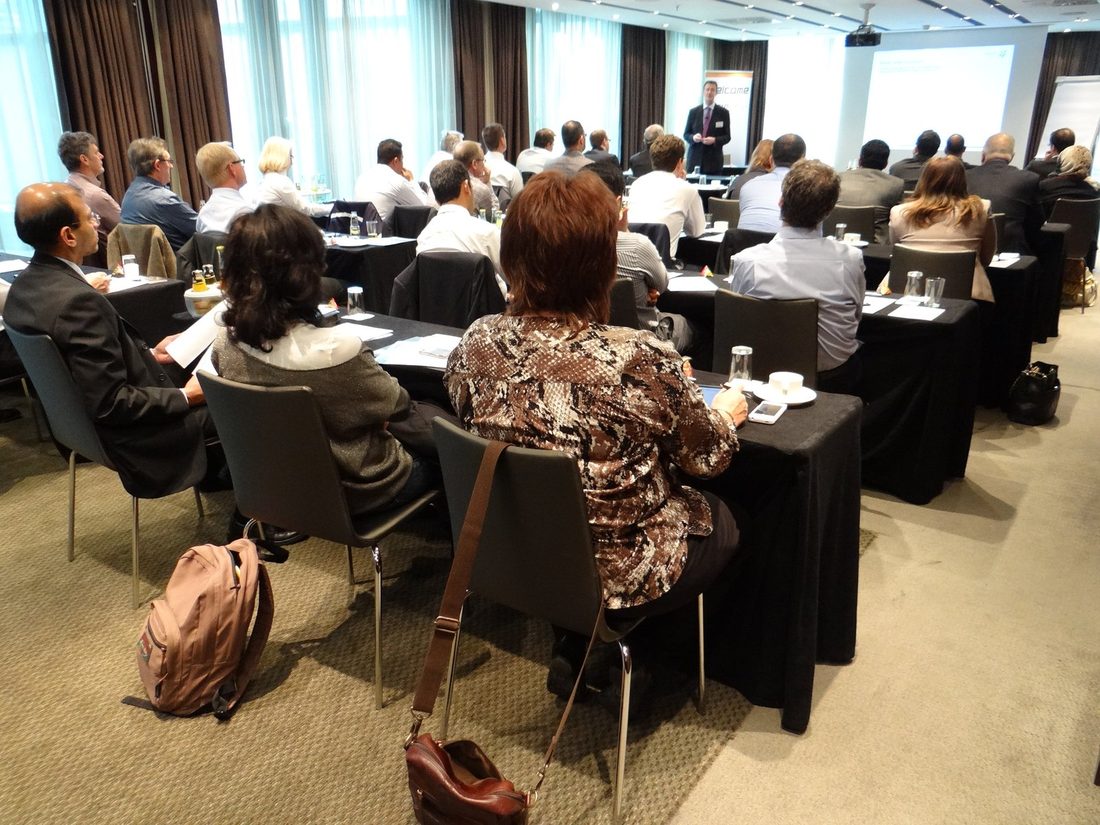 A full seminar room of delegates facing a presenter at a previous Zenith Group event