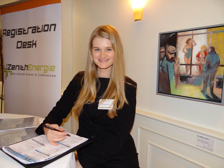 A member of event staff at the registration desk of a previous Zenith Group event